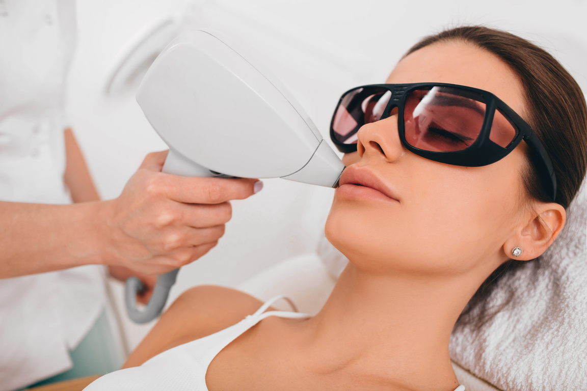 woman getting laser epilation, hair removal on lip area